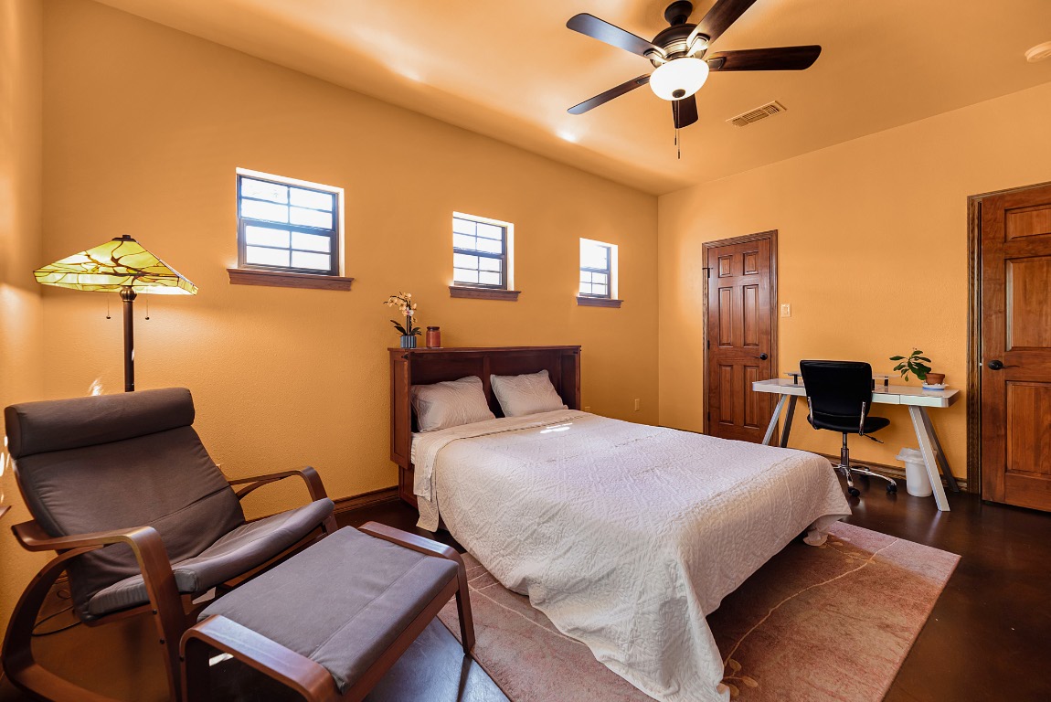 1546 Cox Road Blanco, TX 78606 - Photo 14 of 40 a bed room with a bed and a chair