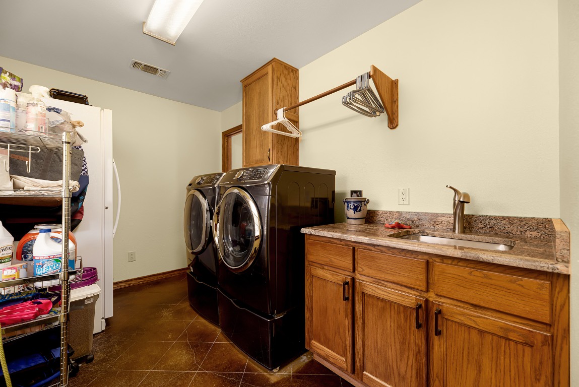 1546 Cox Road Blanco, TX 78606 - Photo 16 of 40 a utility room with sink dryer and washer