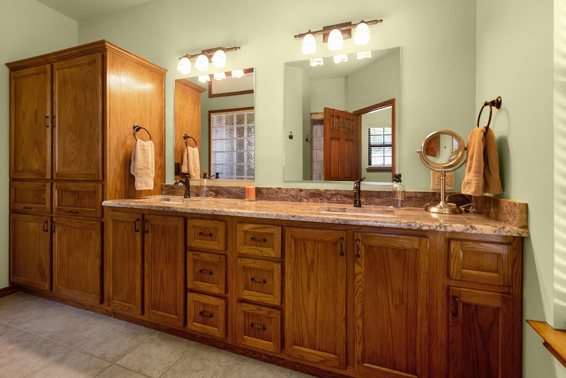 1546 Cox Road Blanco, TX 78606 - Photo 17 of 40 a bathroom with a double vanity sink and a mirror