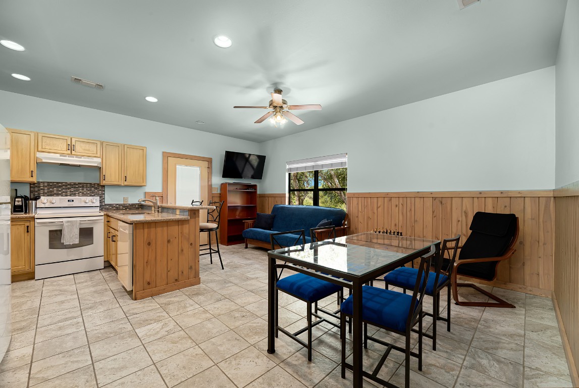 1546 Cox Road Blanco, TX 78606 - Photo 23 of 40 a view of a dining room with furniture and a kitchen