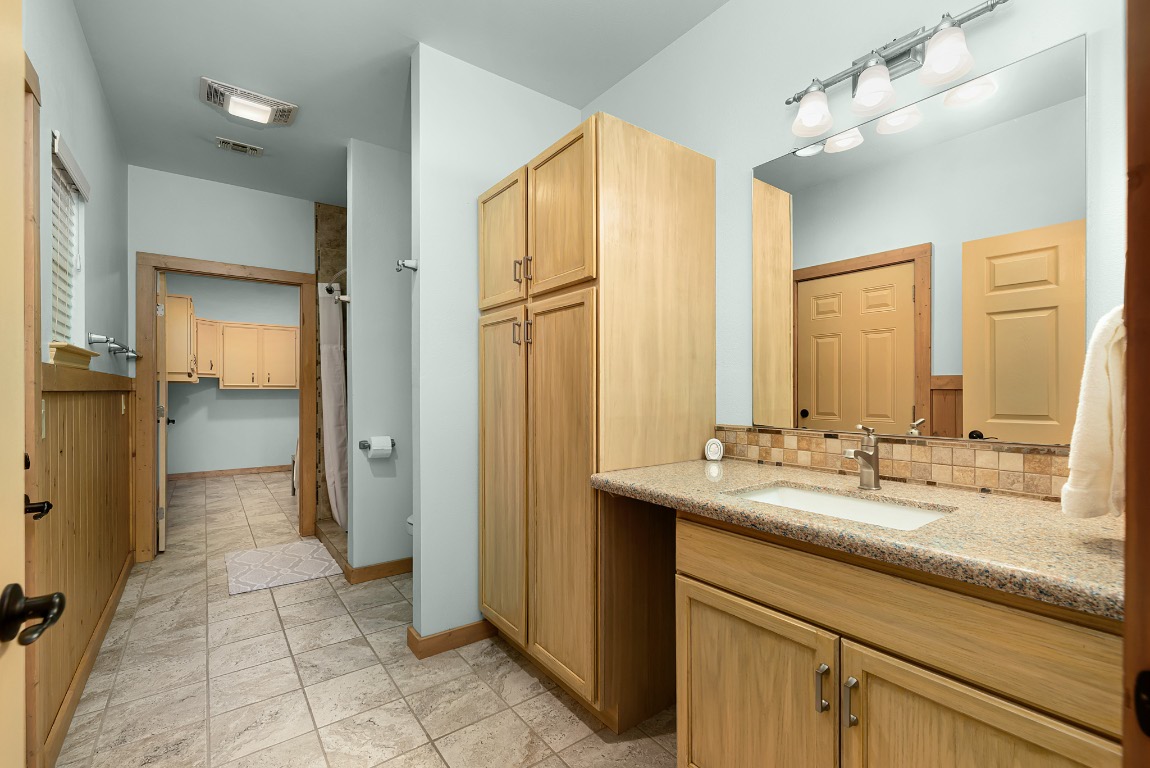 1546 Cox Road Blanco, TX 78606 - Photo 26 of 40 a bathroom with a double vanity sink and a mirror