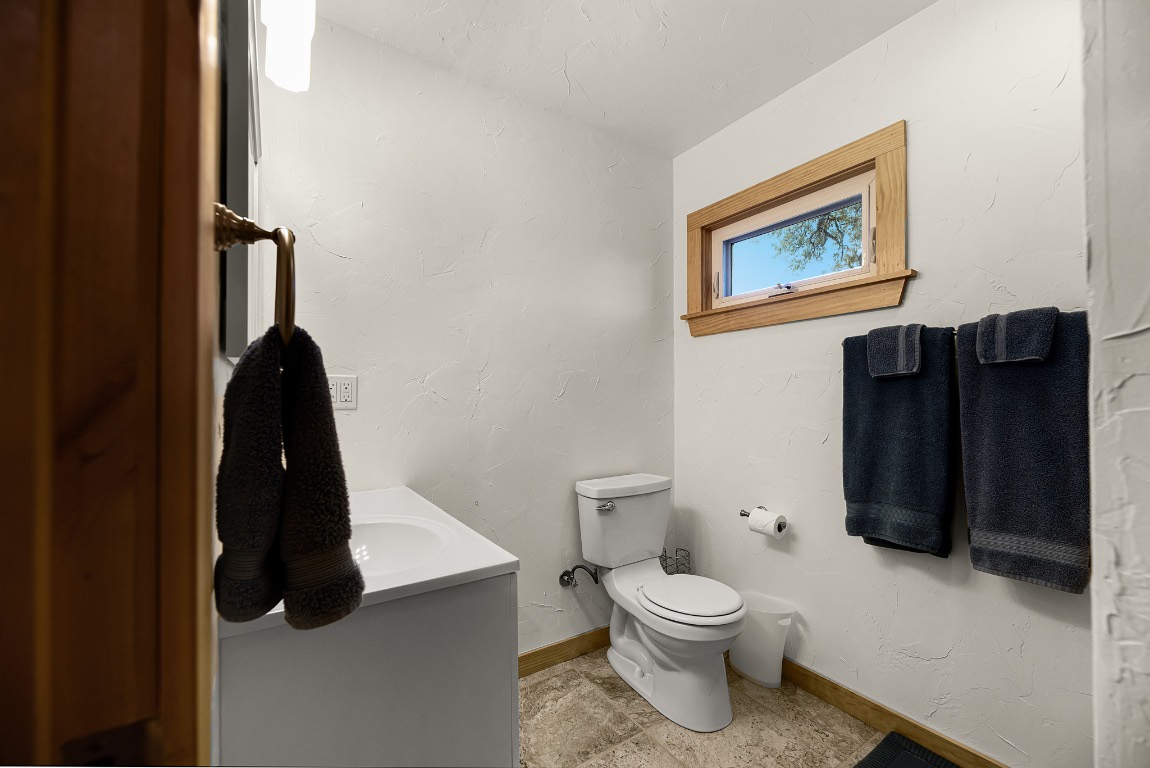 1546 Cox Road Blanco, TX 78606 - Photo 32 of 40 a bathroom with a toilet and a vanity