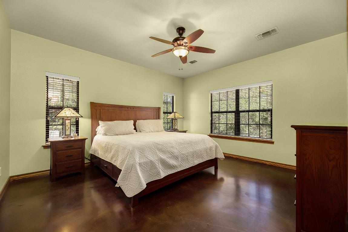1546 Cox Road Blanco, TX 78606 - Photo 33 of 40 a spacious bedroom with a bed and a window