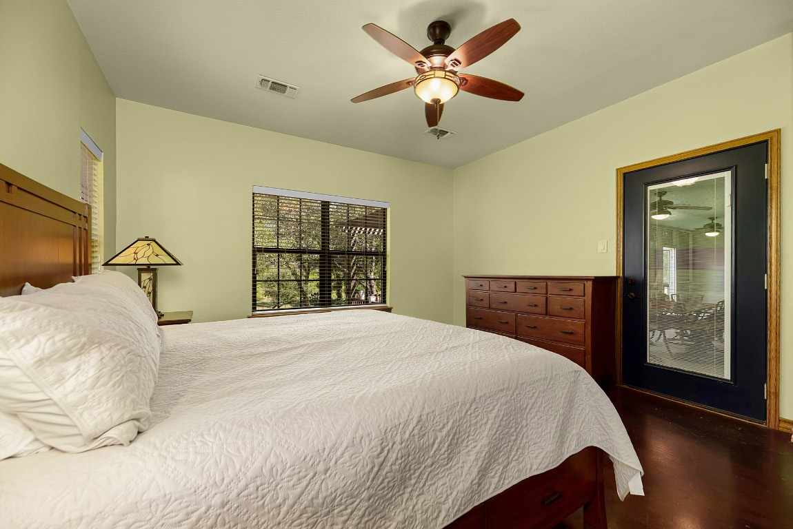 1546 Cox Road Blanco, TX 78606 - Photo 34 of 40 a bedroom with a large bed and a window