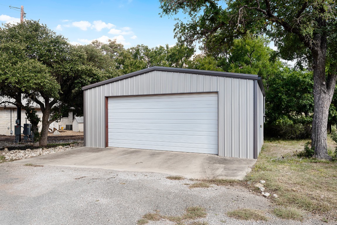 1546 Cox Road Blanco, TX 78606 - Photo 6 of 40 a front view of a house with a yard and garage