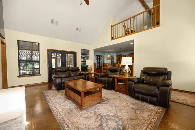 a bedroom with a bed chair and window