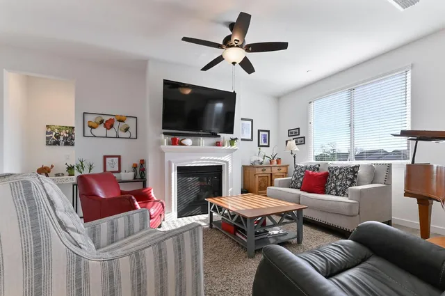 a living room with furniture fireplace and flat screen tv