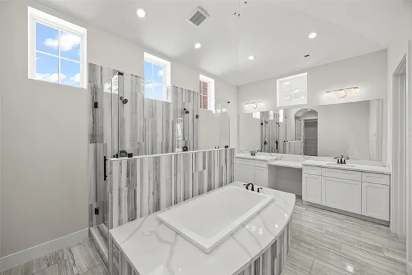 a large white kitchen with a white kitchen island and a sink