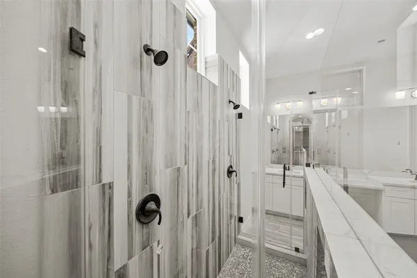 a bathroom with a shower and a tub