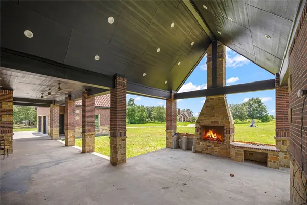 a view of an empty room with a fireplace and a large window