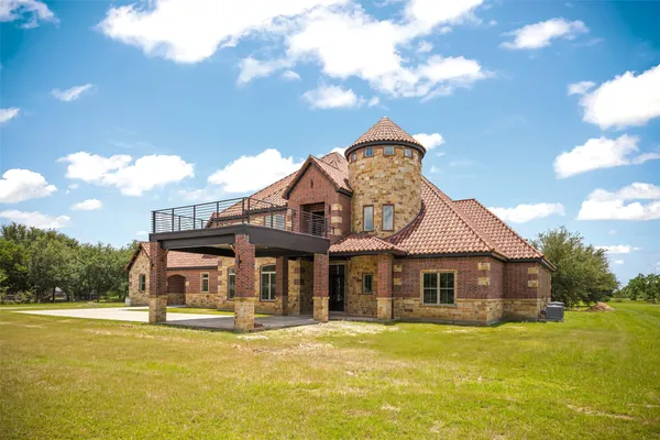 an aerial view of a house with a yard