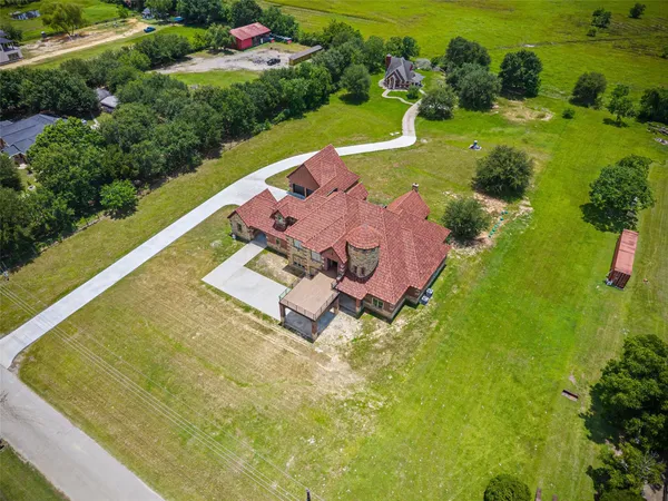 an aerial view of a house with a yard