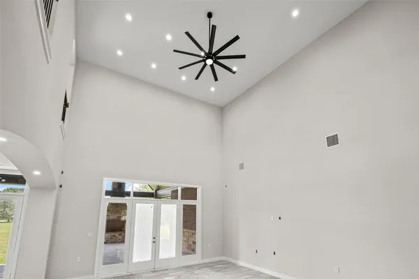 a view of a hallway with a ceiling fan