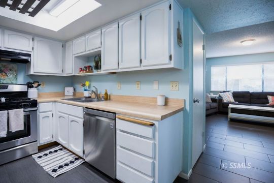 199 East Upjohn Avenue Ridgecrest, CA 93555 - Photo 8 of 30 a kitchen with stainless steel appliances granite countertop a sink stove and cabinets