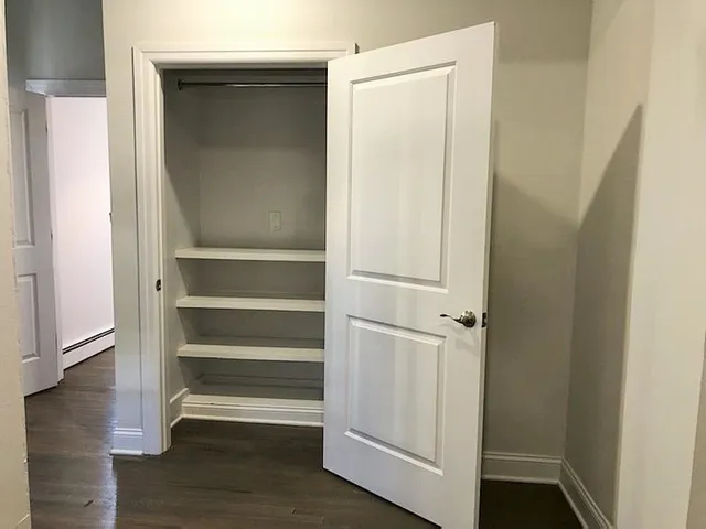 a view of walk in closet with empty racks