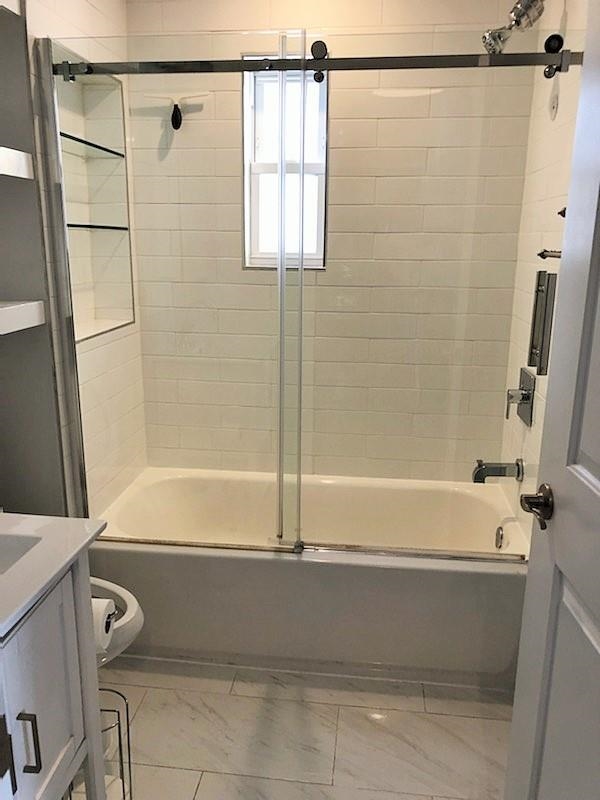 297 4th Street, Unit 2 Jersey City, NJ 07302 - Photo 15 of 19 a bathroom with a shower and a bath tub