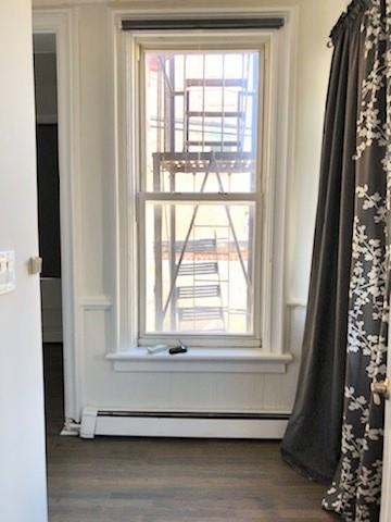 297 4th Street, Unit 2 Jersey City, NJ 07302 - Photo 10 of 19 a living room with a window and a wooden floor