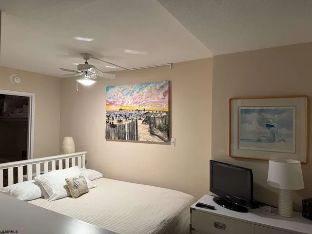 a bedroom with a bed and a painting on the wall