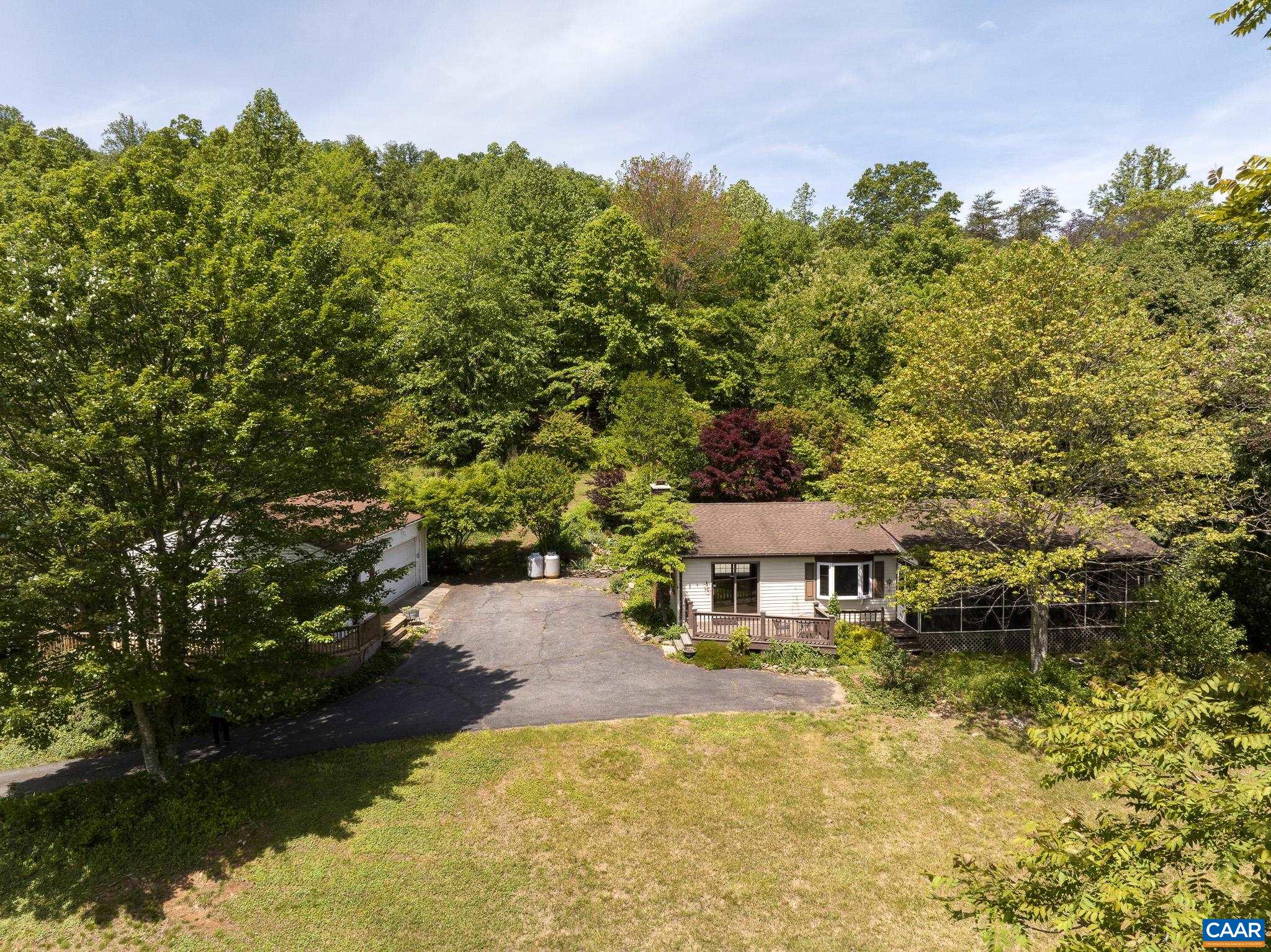 a house with swimming pool in front of it