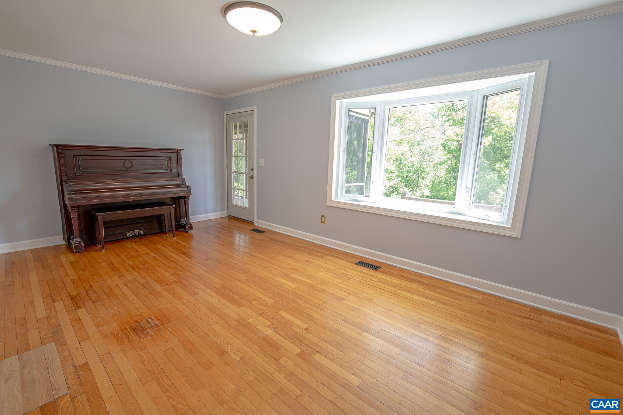 3033 Bacon Hollow Road Dyke, VA 22935 - Photo 16 of 66 a view of an empty room with wooden floor and a window