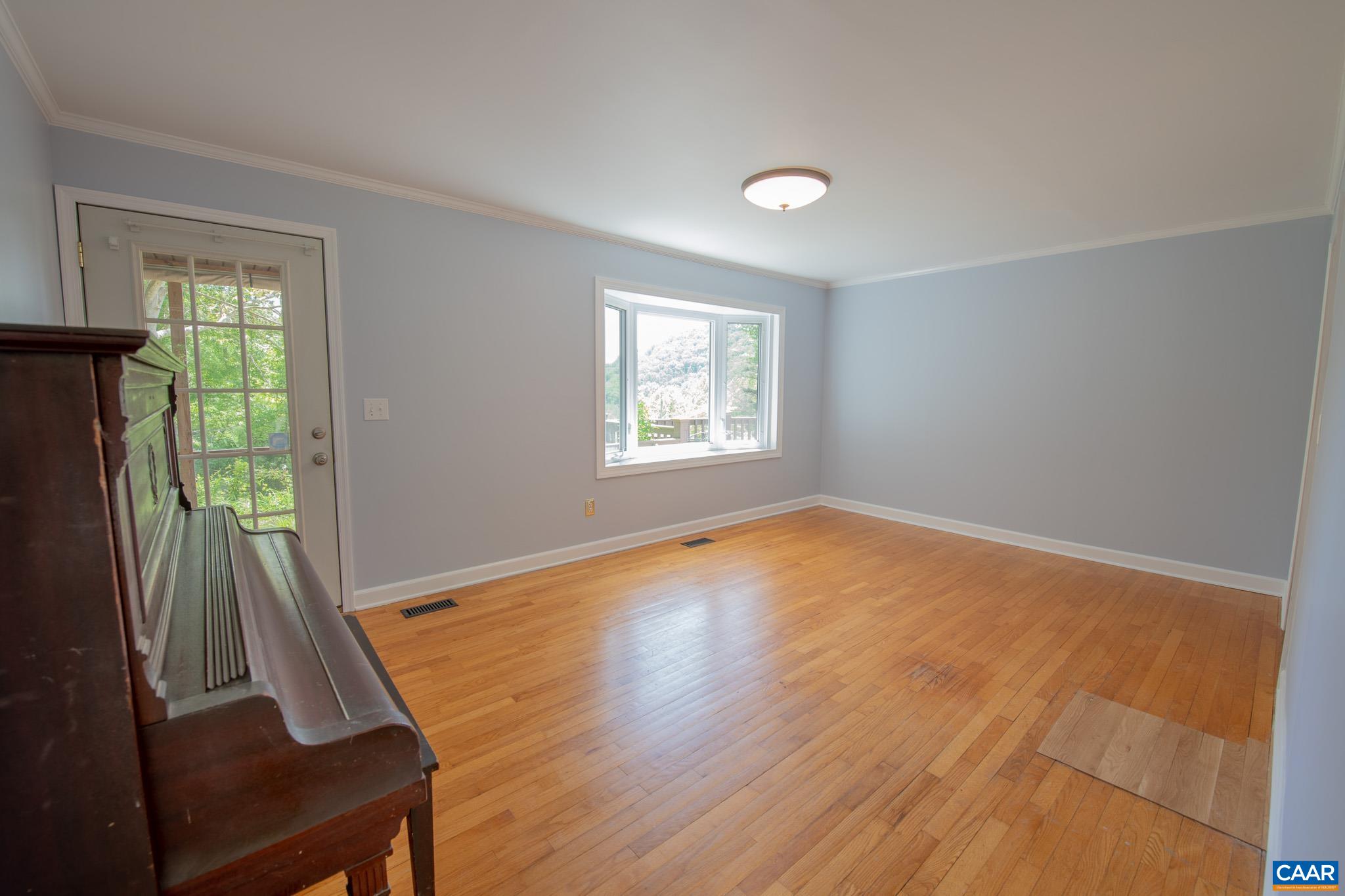 3033 Bacon Hollow Road Dyke, VA 22935 - Photo 17 of 66 a view of an empty room with wooden floor and a window