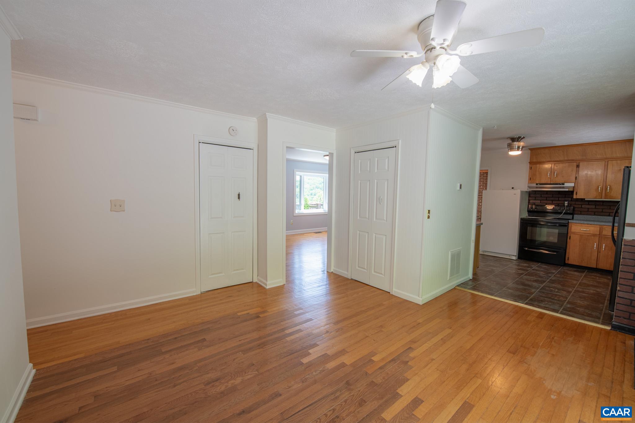 3033 Bacon Hollow Road Dyke, VA 22935 - Photo 18 of 66 a view of a kitchen with wooden floor and a ceiling fan