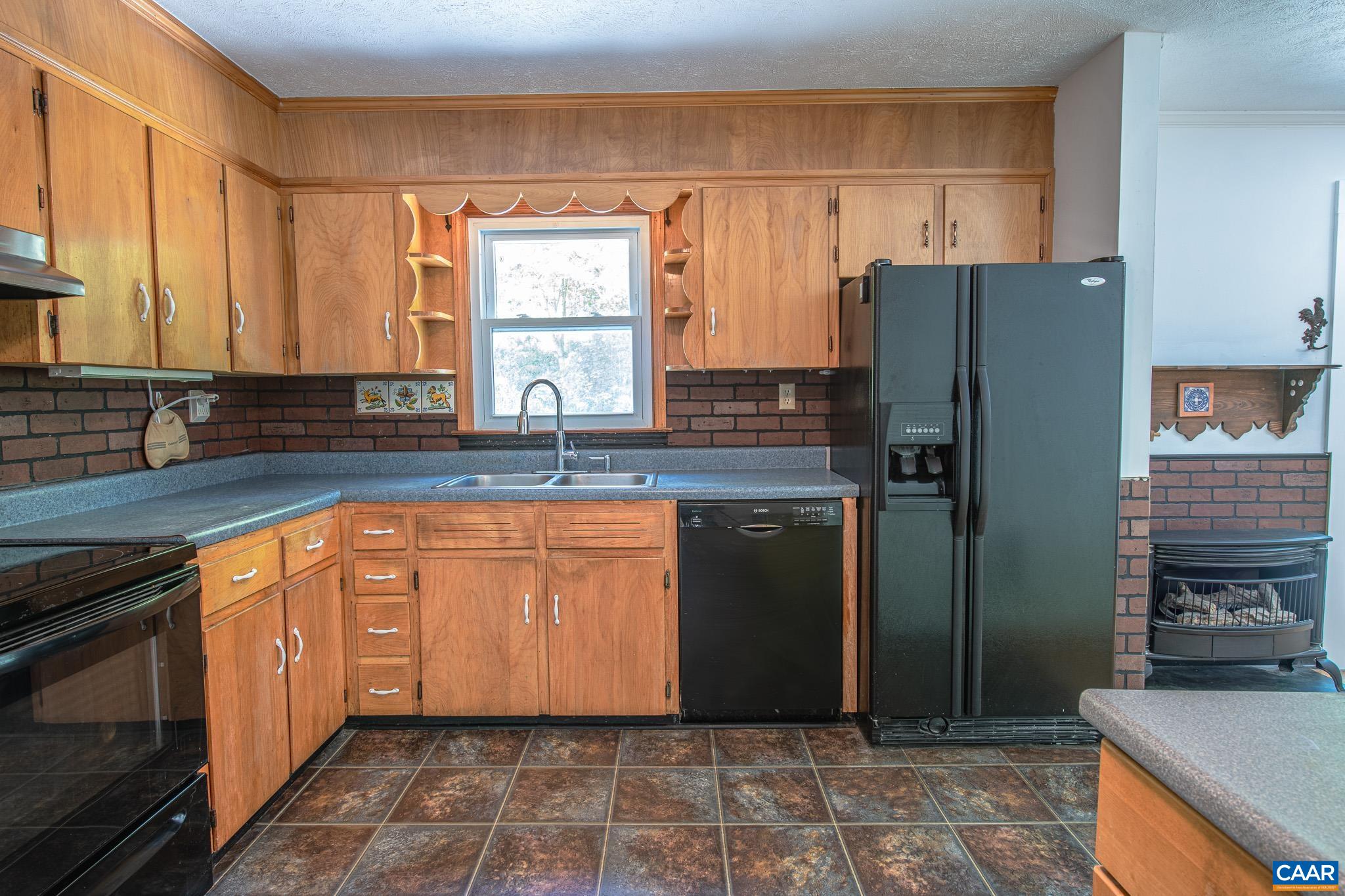 3033 Bacon Hollow Road Dyke, VA 22935 - Photo 20 of 66 a kitchen with granite countertop a refrigerator a stove and a sink
