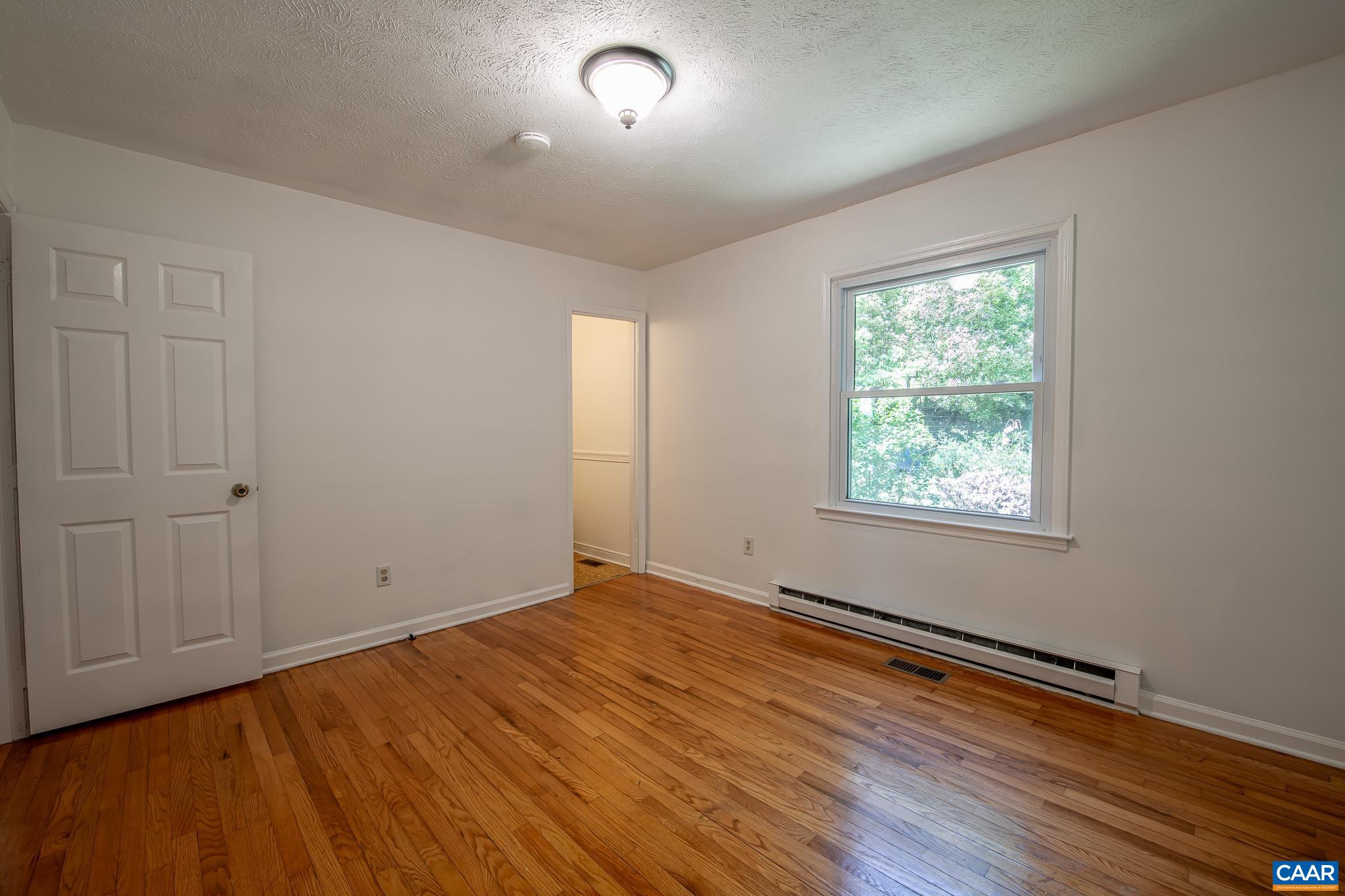 3033 Bacon Hollow Road Dyke, VA 22935 - Photo 26 of 66 an empty room with wooden floor and windows