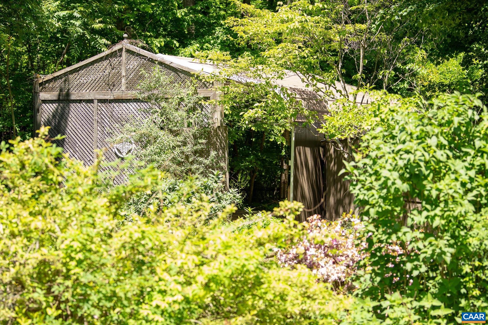 3033 Bacon Hollow Road Dyke, VA 22935 - Photo 37 of 66 a backyard of a house with lots of green space and garden
