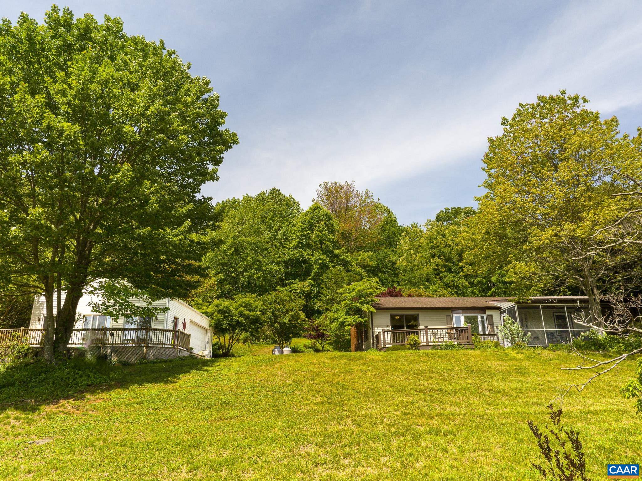 3033 Bacon Hollow Road Dyke, VA 22935 - Photo 62 of 66 a front view of house with yard and trees in the background