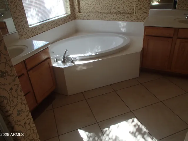 a bath tub sitting in a bathroom next to a window