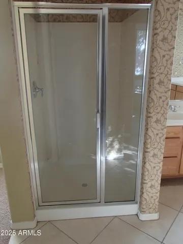a view of staircase with wooden floor and white walls