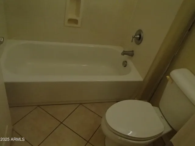 a view of a big room with windows and chandelier fan