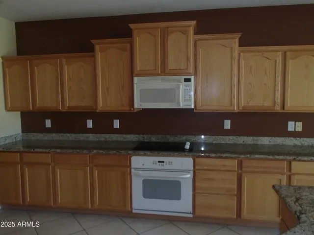 a kitchen with granite countertop cabinets and stainless steel appliances