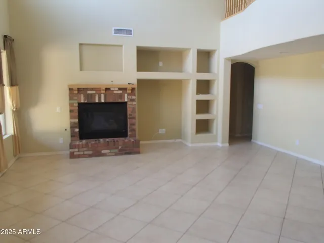 a view of a livingroom with an empty space and a fireplace