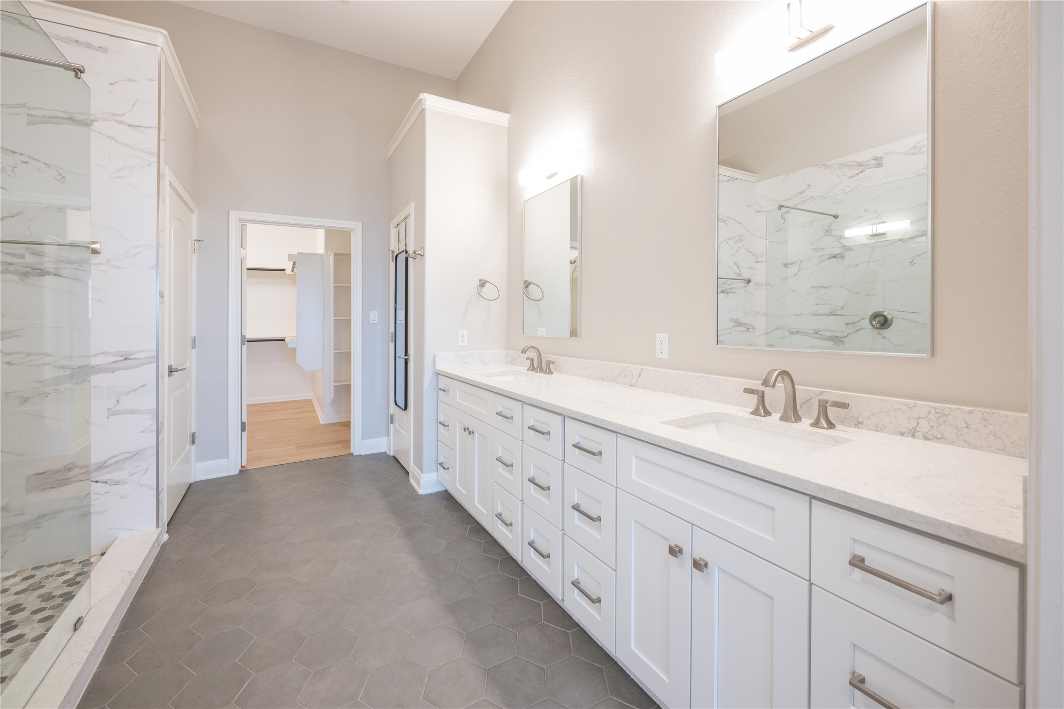 232 Sunrise Ridge Loop Austin, TX 78738 - Photo 18 of 37 Spacious bathroom featuring a dual vanity with white shaker-style cabinetry and stone countertops