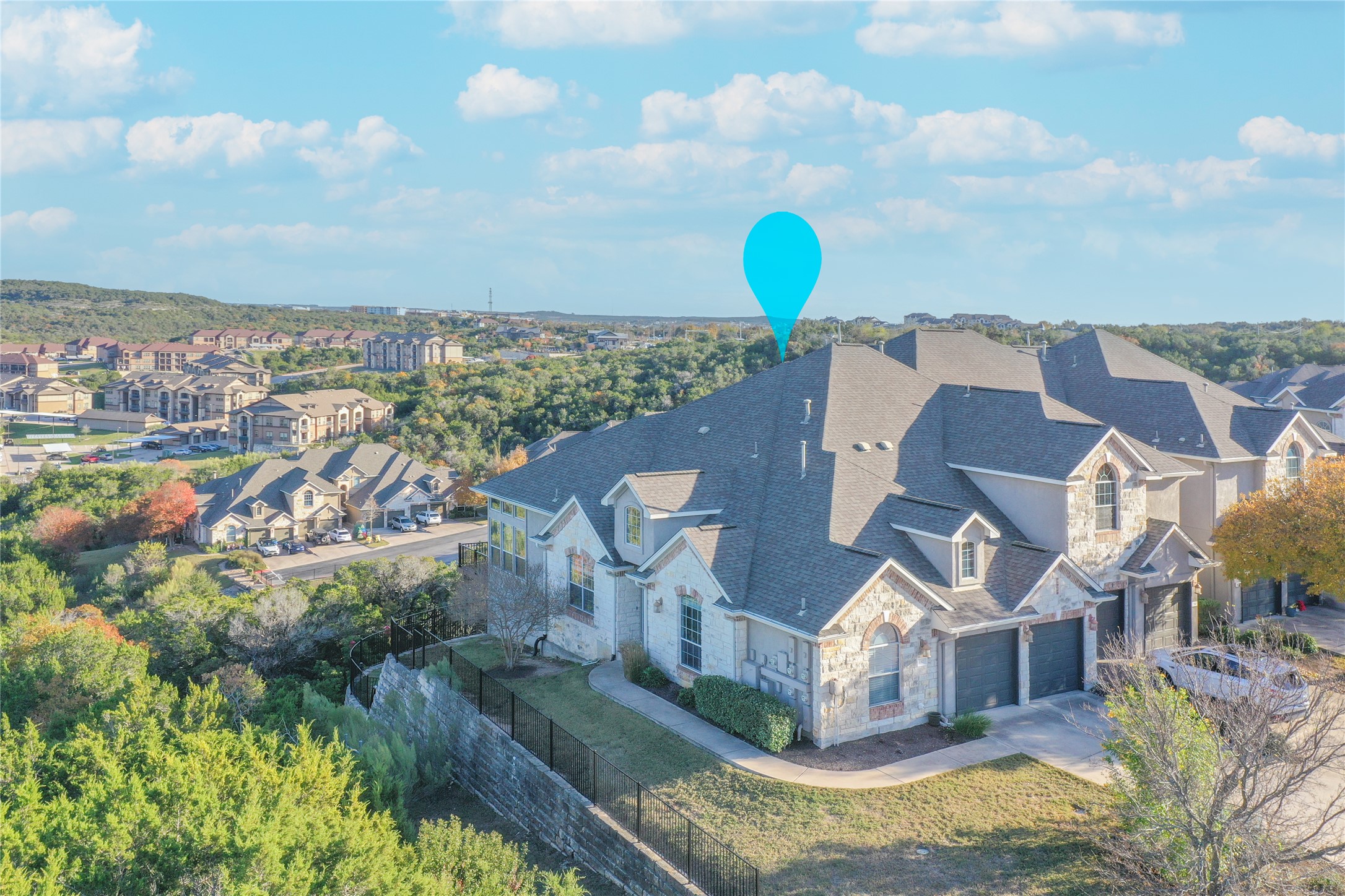 232 Sunrise Ridge Loop Austin, TX 78738 - Photo 34 of 37 Stone and stucco exterior residence featuring a multi-gabled roofline, dormer windows, and a multi-car garage