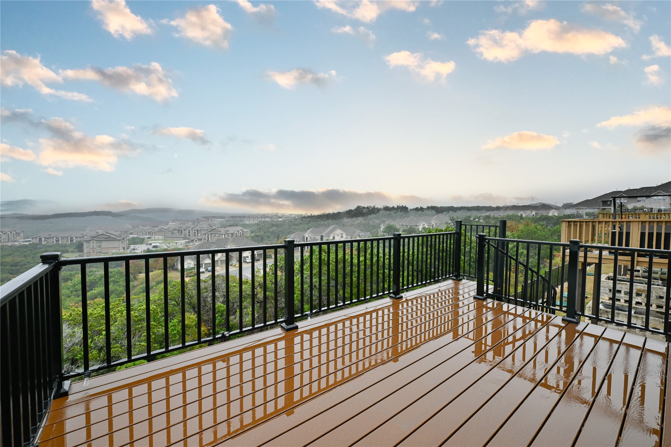 232 Sunrise Ridge Loop Austin, TX 78738 - Photo 37 of 37 Expansive outdoor deck featuring composite decking, black metal railings, and panoramic regional scenery