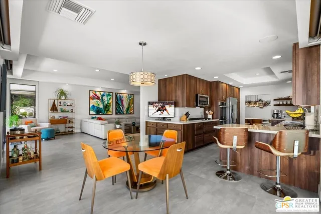 a kitchen with stainless steel appliances granite countertop a refrigerator oven a sink and dishwasher