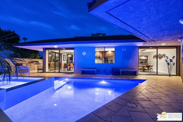a view of a patio with table and chairs and potted plants