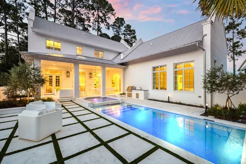 a view of a house with a swimming pool and a yard