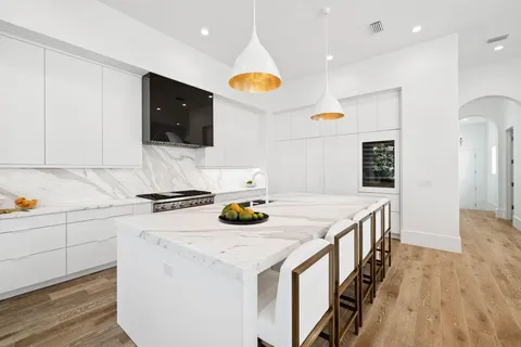 a bedroom with a bed and a couch next to a window