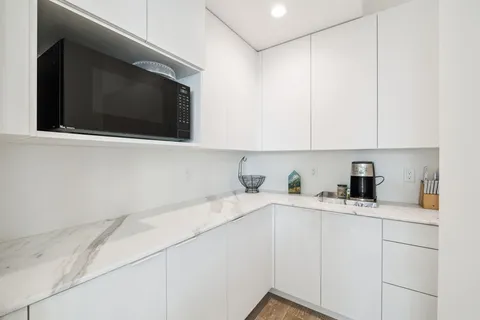 a bathroom with a double vanity sink mirror and bathtub