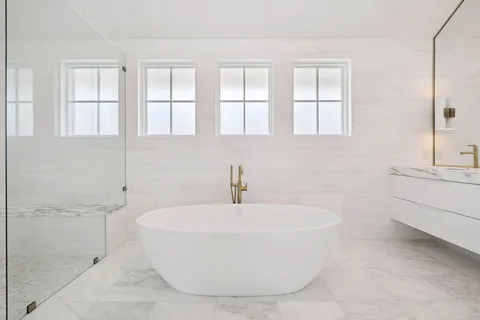 a bedroom with a bed and a potted plant