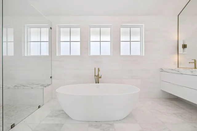 a bedroom with a bed and a potted plant