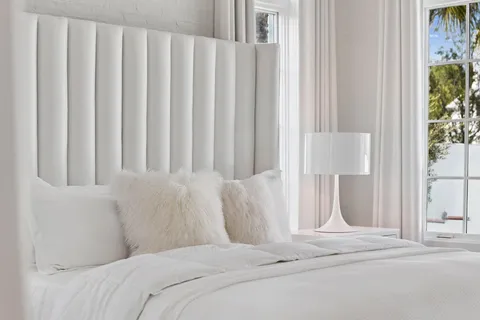 a bedroom with a large bed and a window