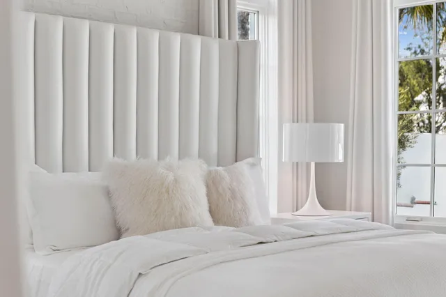 a bedroom with a large bed and a window