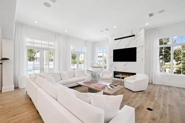 a living room with furniture and a wooden floor