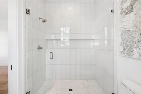 a bathroom with a toilet and a shower curtain