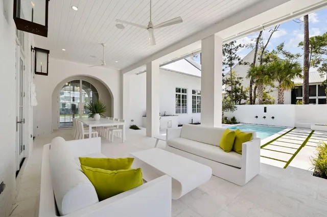 a view of a house with backyard and sitting area